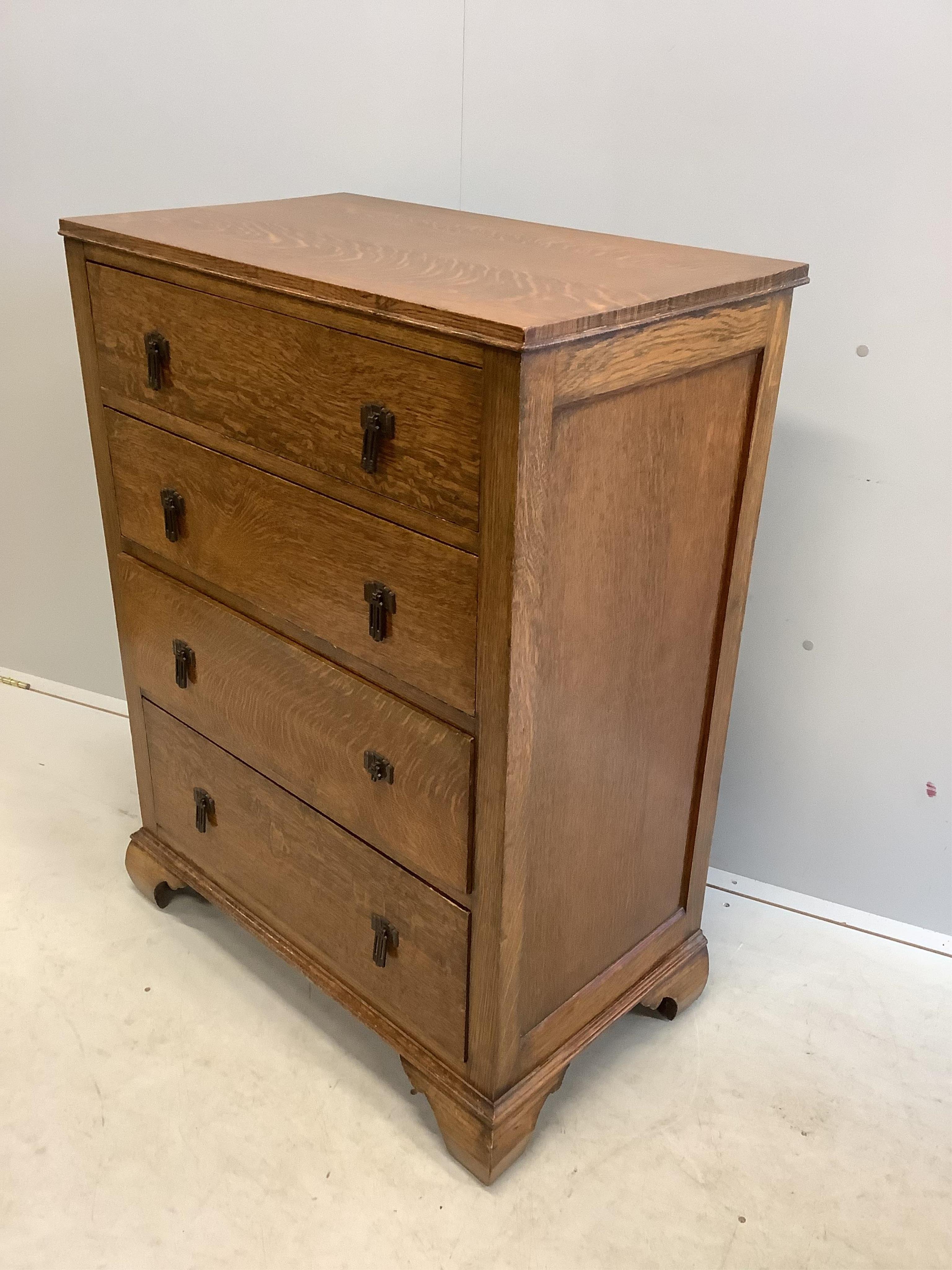 An early 20th century oak chest of four drawers, width 76cm, depth 46cm, height 104cm. Condition - good, one metal handle broken but piece is present